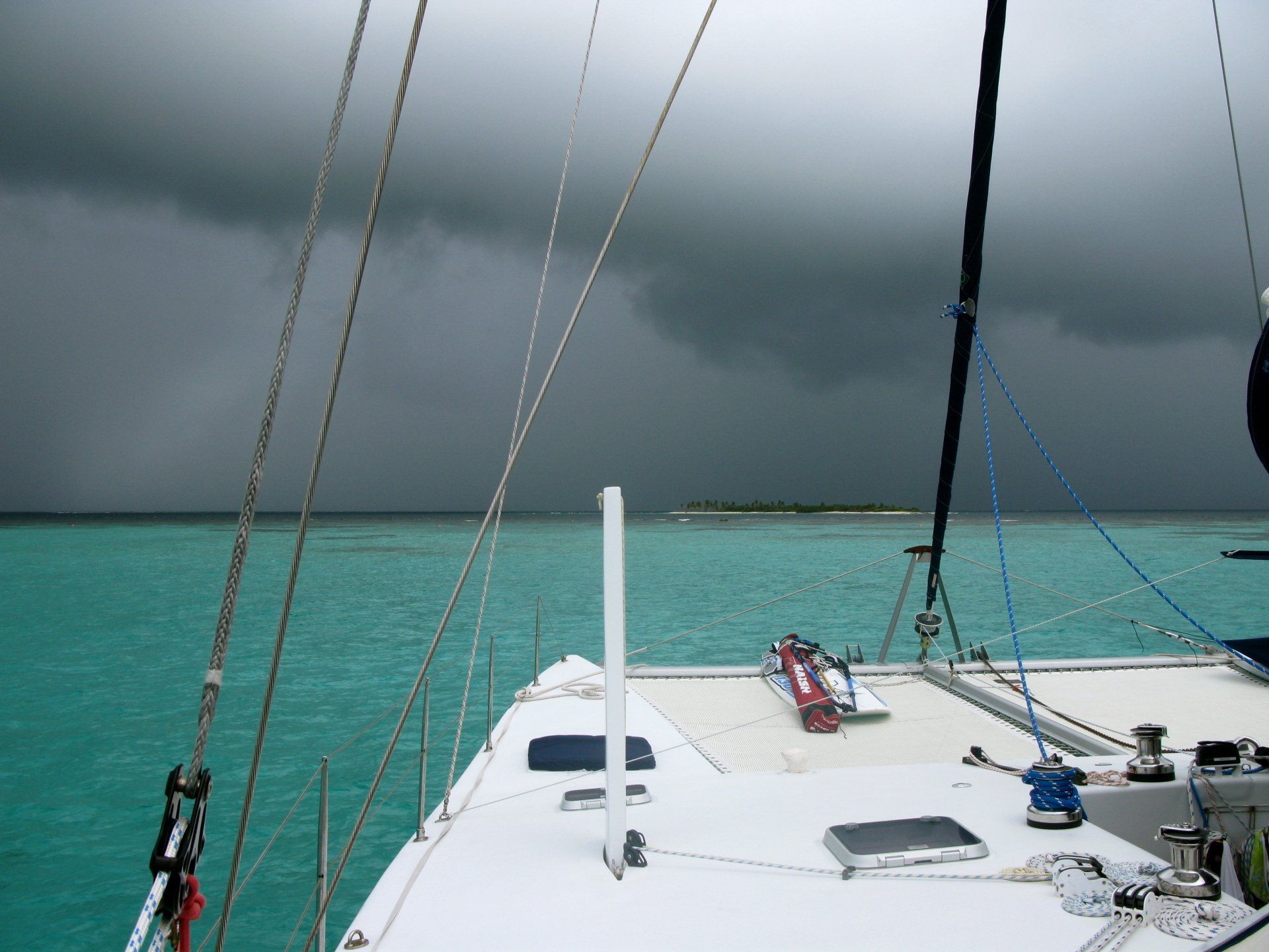 A sailboat in the ocean on a cloudy day