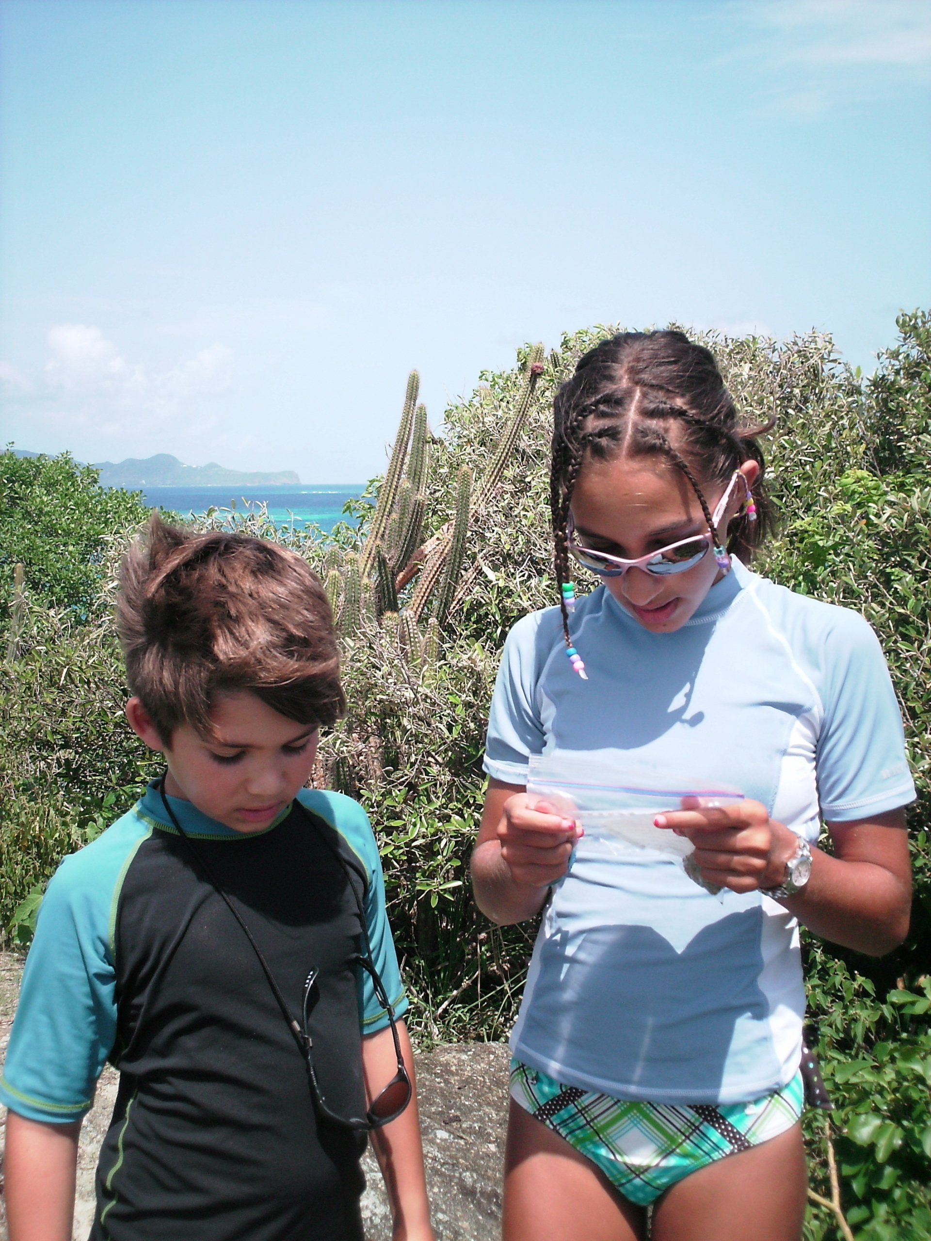 A boy and a girl are looking at a piece of paper
