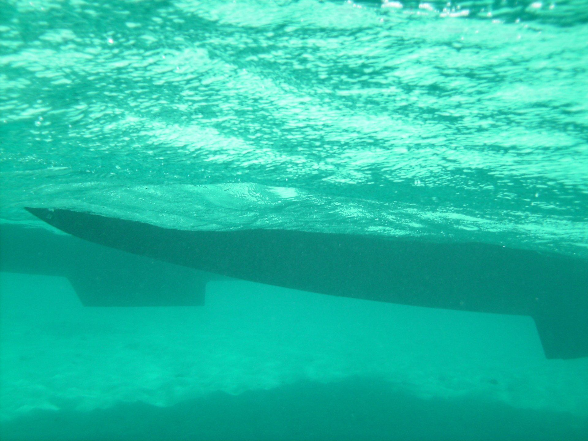 A boat is floating on top of a body of water
