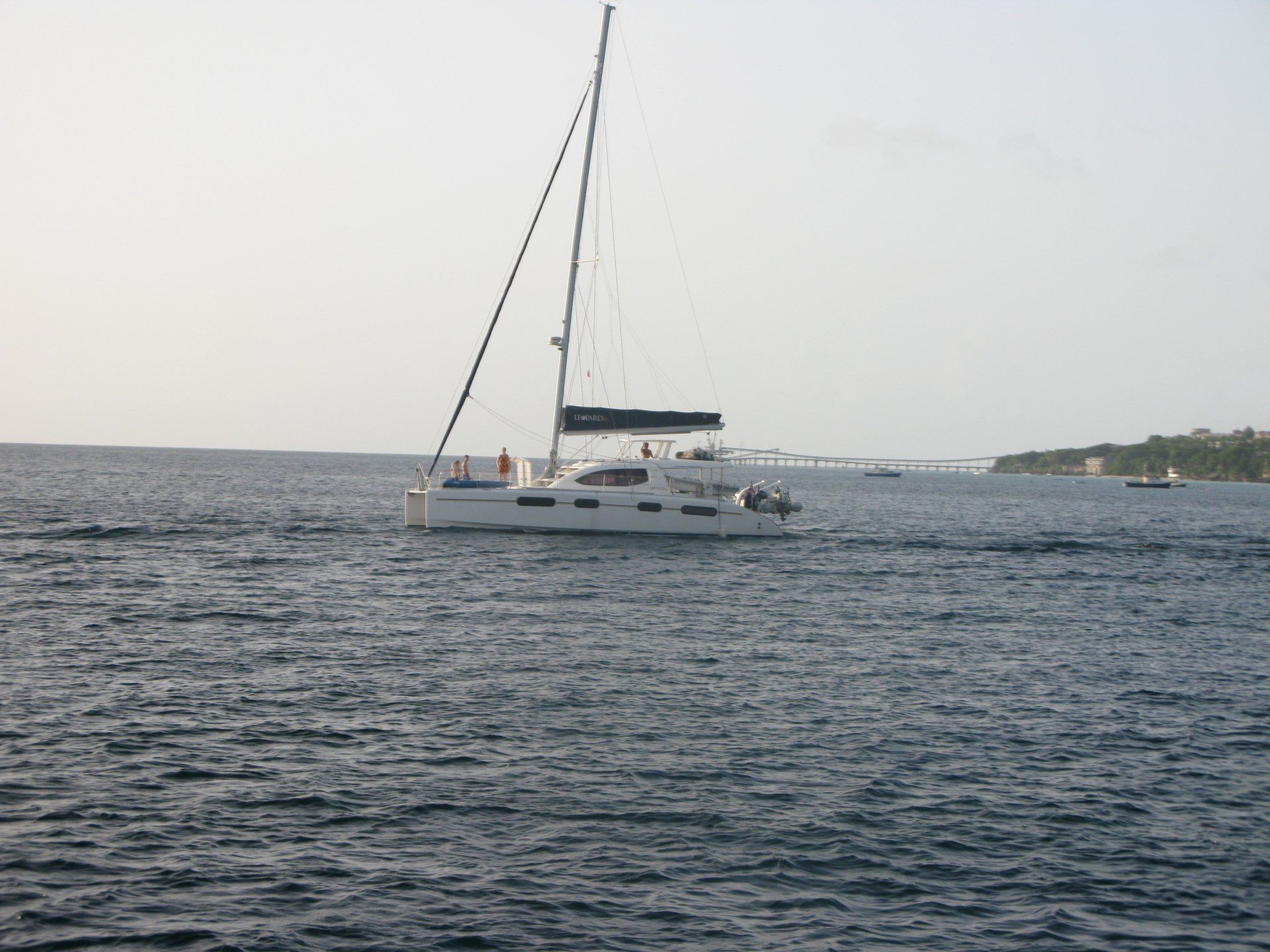 A sailboat is in the middle of a large body of water