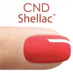 A close up of a red nail with cnd shellac written on it