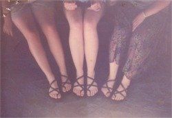 three pairs of sandals on the roommates' feet