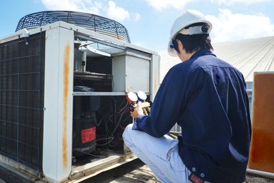 Air Condition Service — Technician Checking The Air Conditioner in Greenville, South Carolina Air Condition Service — Technician Checking The Air Conditioner in Greenville, South Carolina
