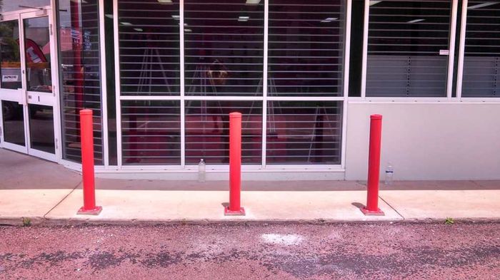 Three red poles — Gates Darwin in Pinelands, NT