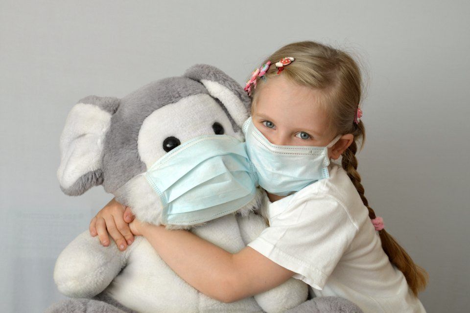 bambina con mascherina chirurgica monouso