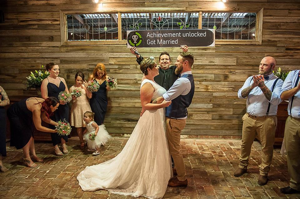 A bride and groom are dancing in front of their wedding party.