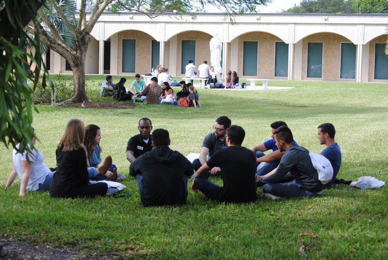 Several small groups of attendees gathered in the lawn.