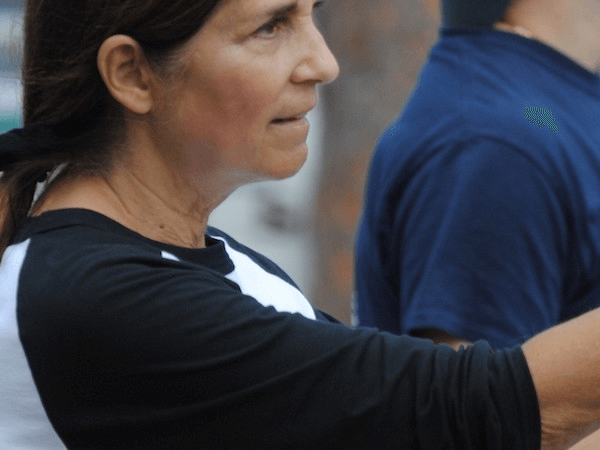 Softball game, woman up at bat.