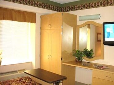 Cabinet and Flat screen TV in a room — Skilled Nursing in Parma, OH Cabinet and Flat screen TV in a room — Skilled Nursing in Parma, OH