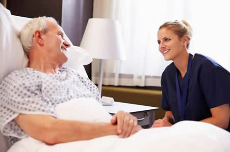 Senior in bed with the nurse — Skilled Nursing in Parma, OH Senior in bed with the nurse — Skilled Nursing in Parma, OH
