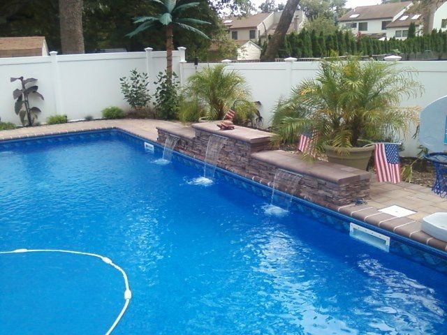 a swimming pool with a waterfall on the side of it