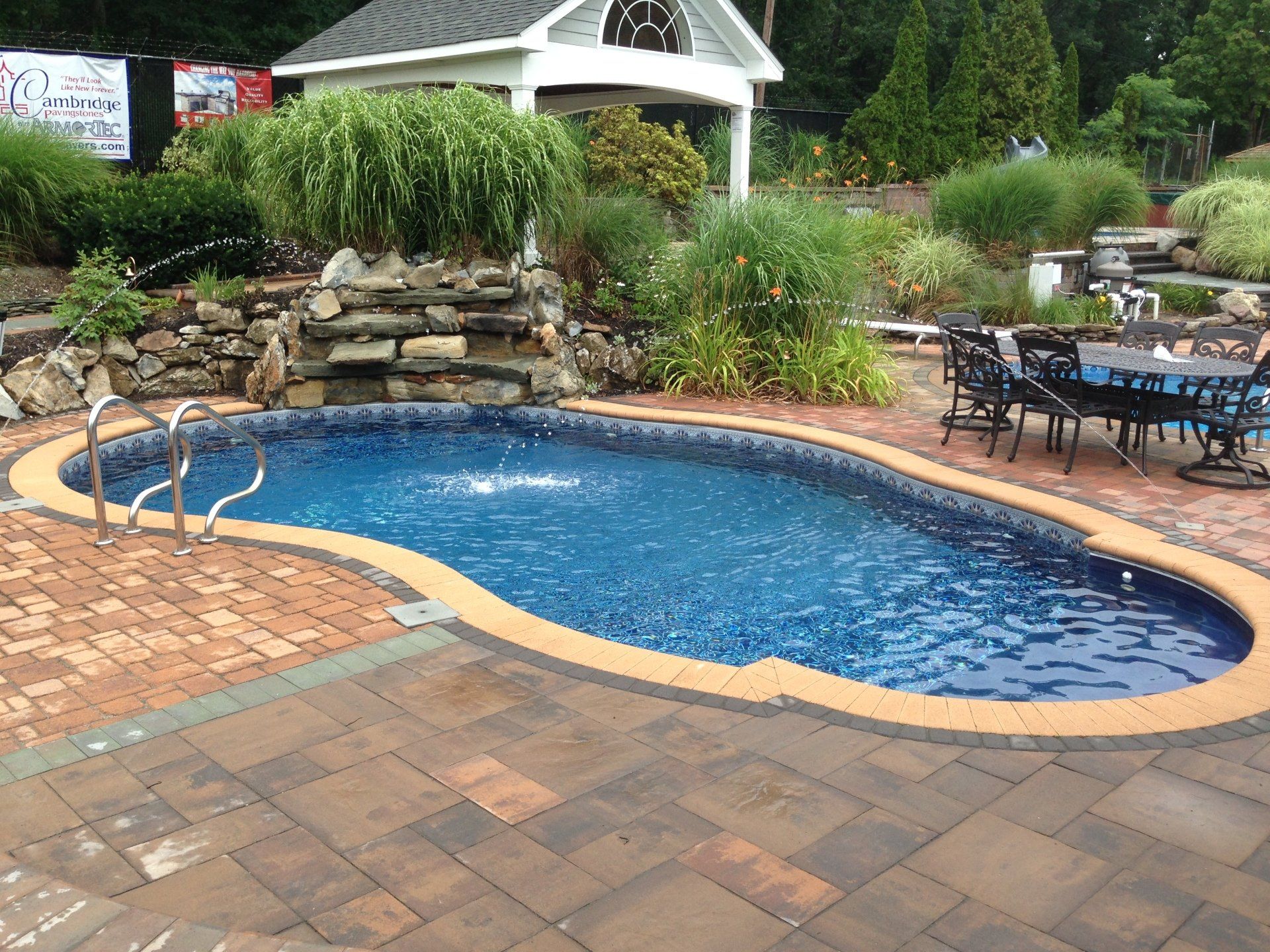 a swimming pool with a sign that says cambridge on it
