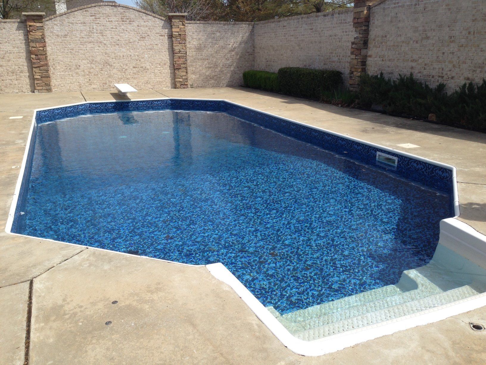 a large swimming pool with a diving board in it