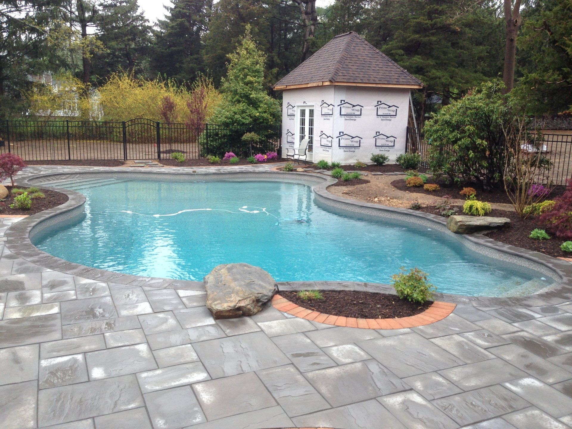 a large swimming pool with a gazebo in the background