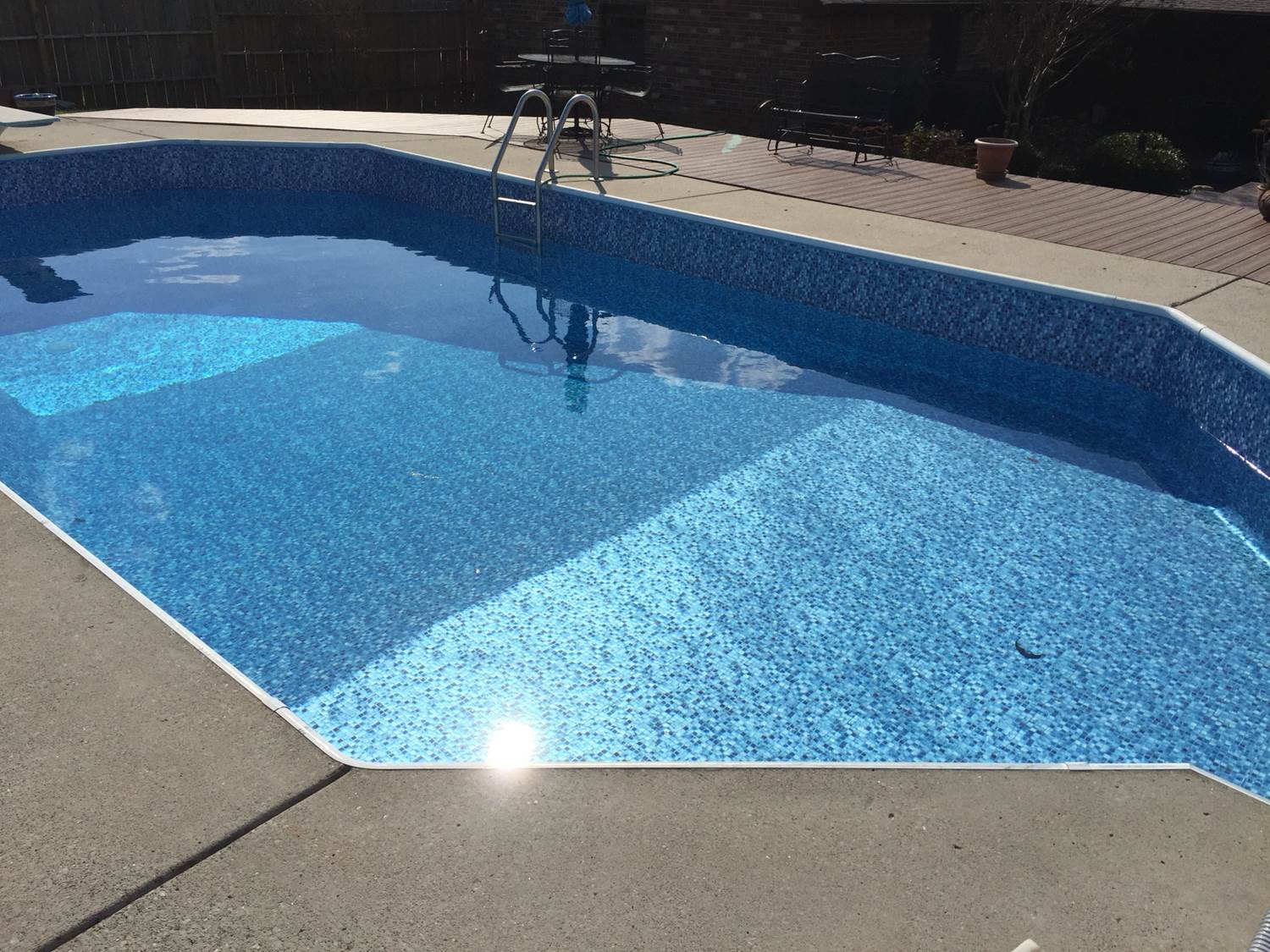 a large swimming pool with a ladder in it