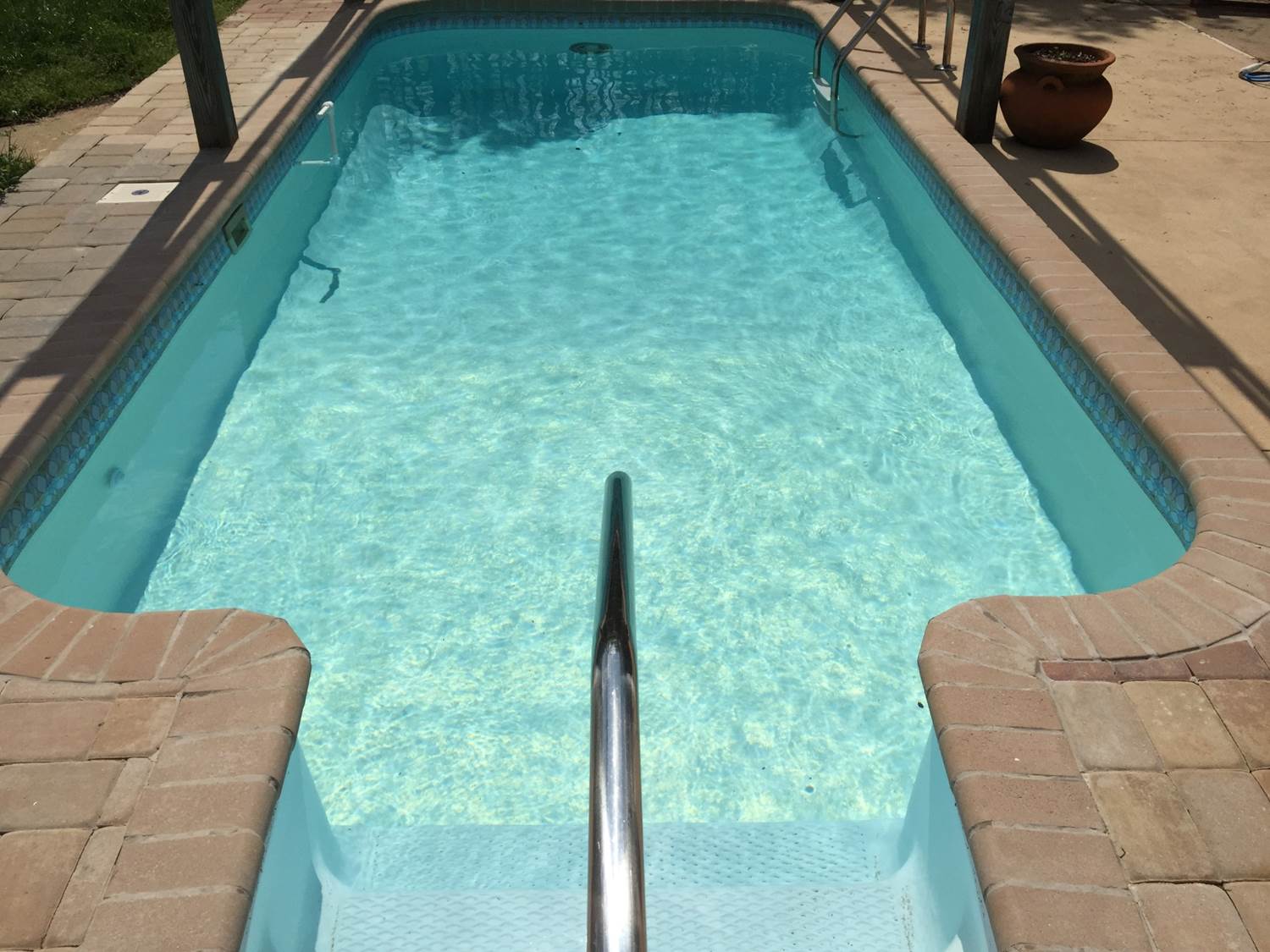 a swimming pool with a staircase leading to it