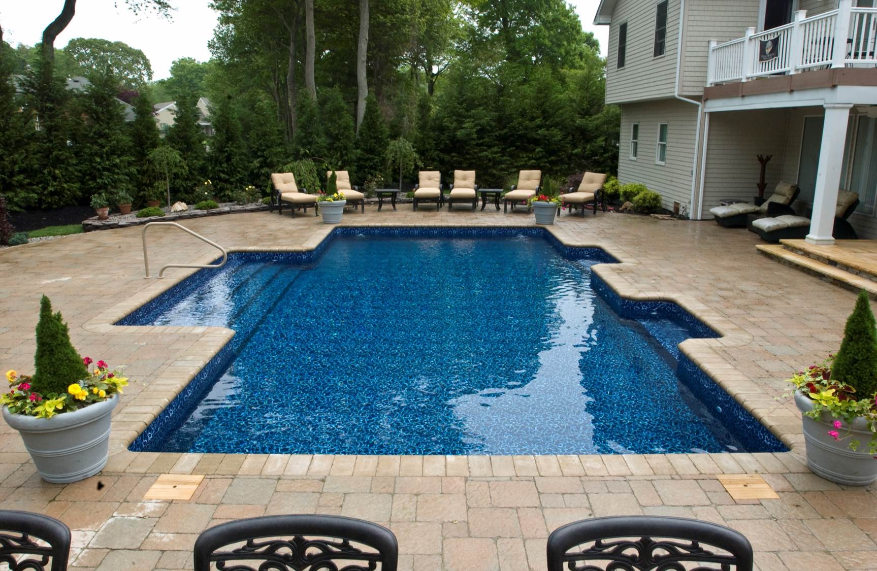 a large swimming pool in the backyard of a house