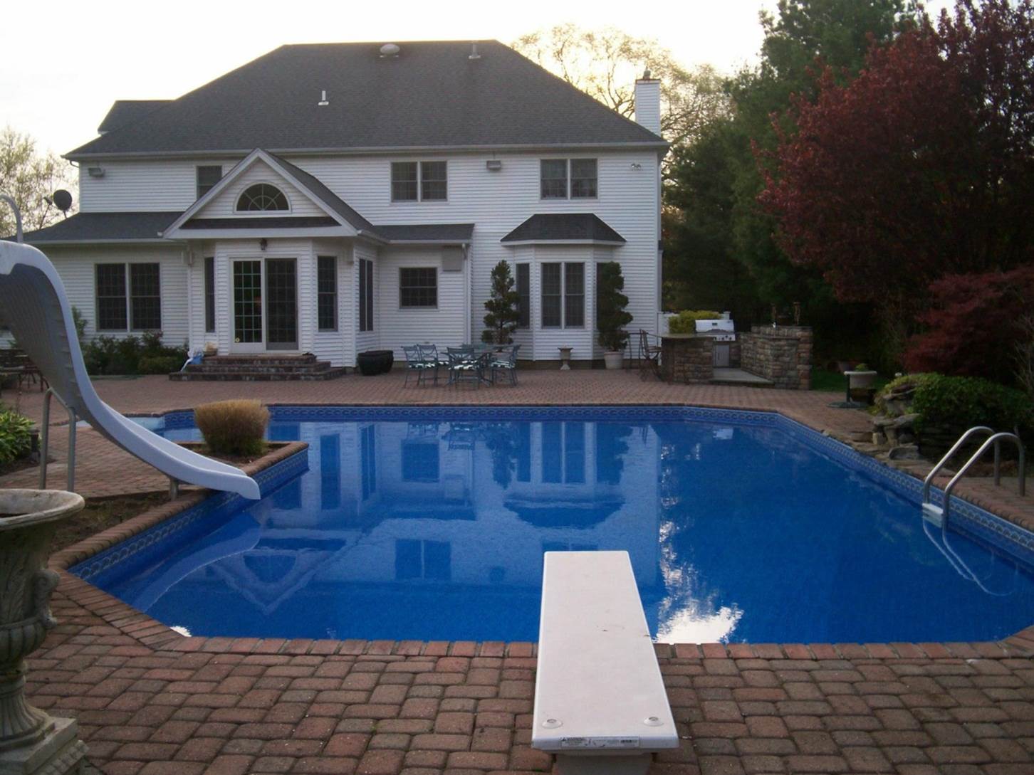 a large house with a large swimming pool in front of it