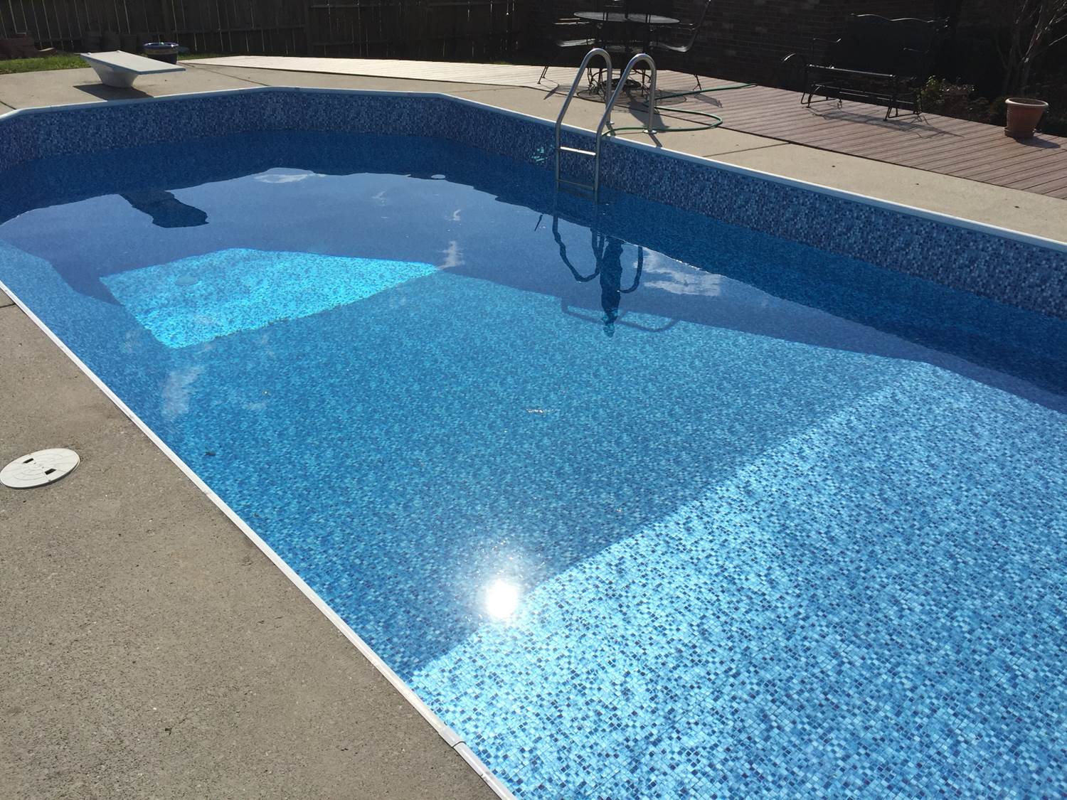a large swimming pool with a ladder in it