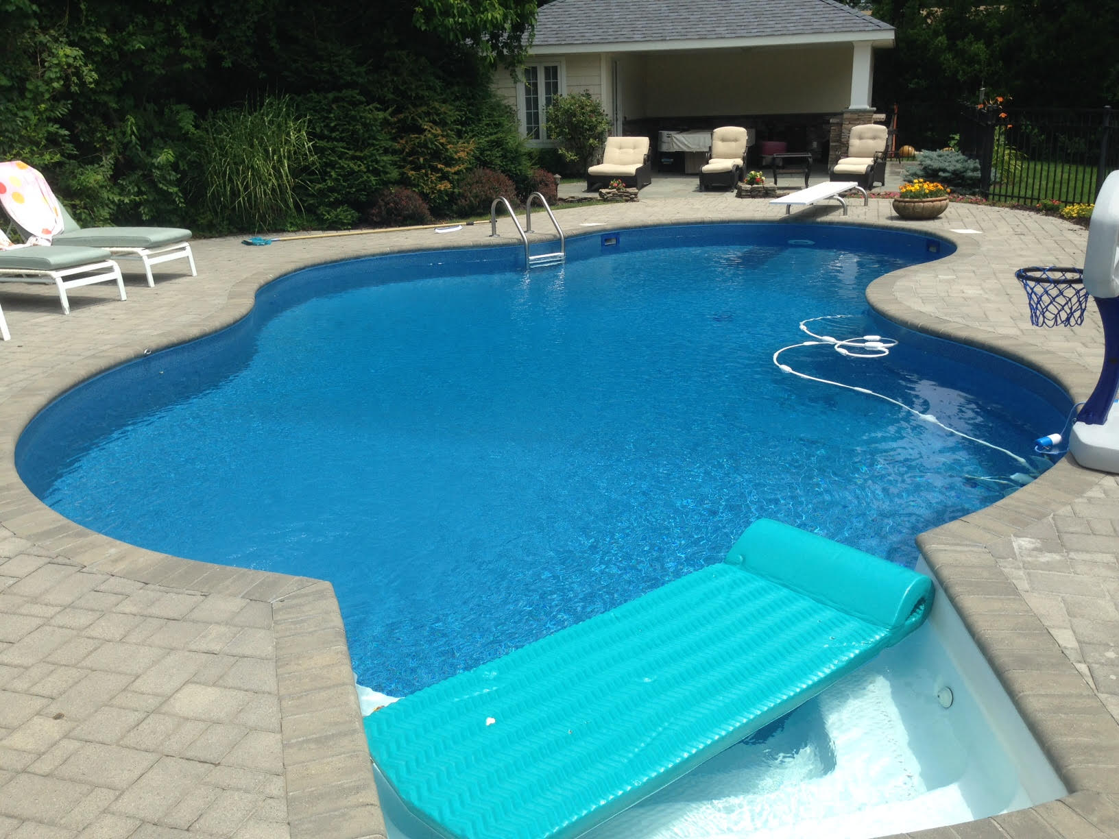 a swimming pool with a blue raft in it