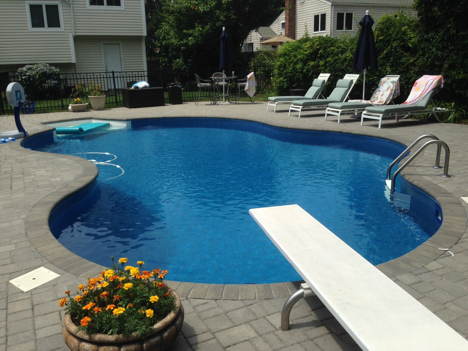 a swimming pool with a diving board in the middle