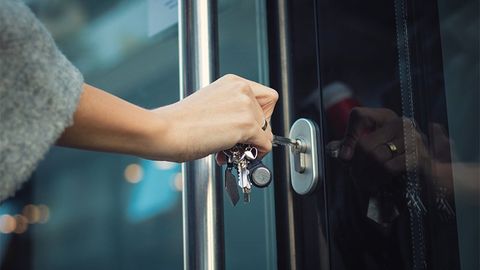 Woman Unlocking Commercial Entry Door — Saint Louis, MO — Krause Key & Lock Service Woman Unlocking Commercial Entry Door — Saint Louis, MO — Krause Key & Lock Service