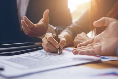 Power of Attorney — Business Woman Signing a Contract in Miami Lakes, FL