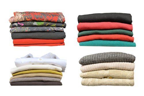 quattro pile diverse di vestiti puliti e piegati