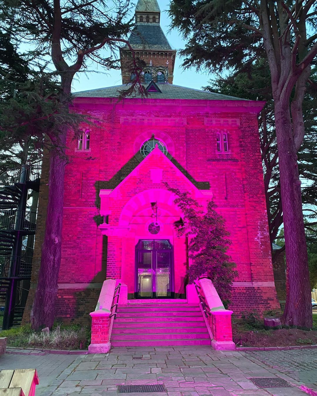 Late evening, purple light illuminating an impressive detached building.