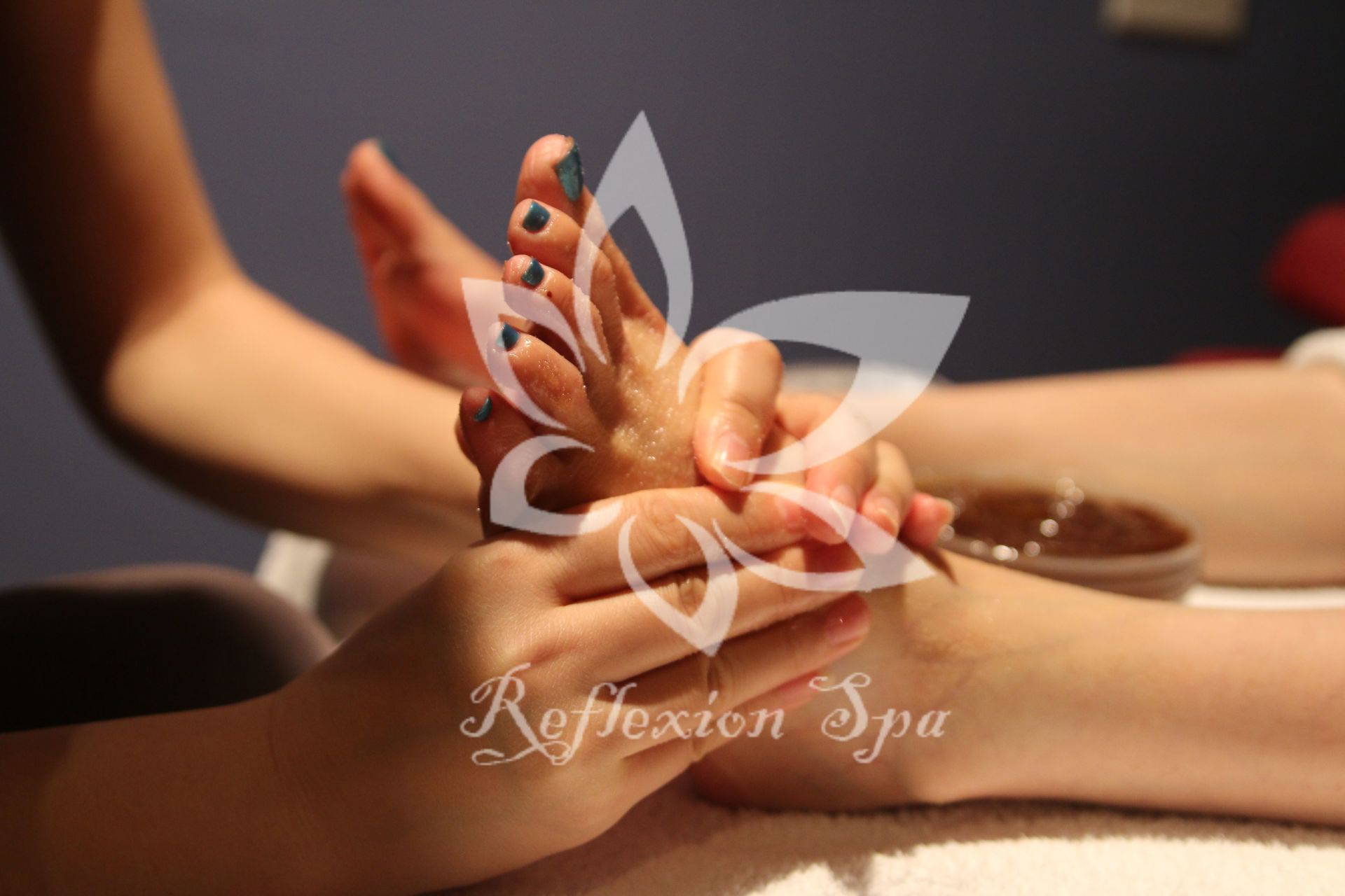 A person is getting a foot massage in a reflexion spa