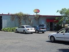 A couple of cars are parked in front of a building.