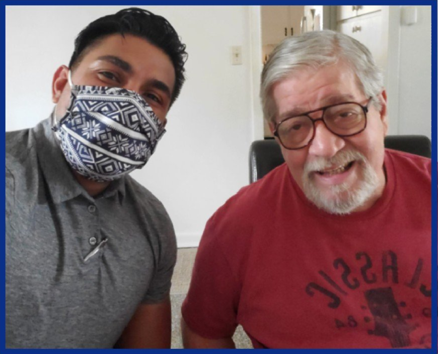 A man wearing a mask and a man wearing a pizza shirt