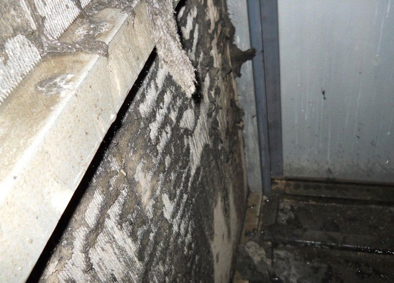 a dirty condenser coil leaning on the wall