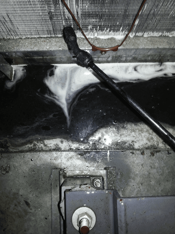 a close up of a pipe with a hose attached to it .