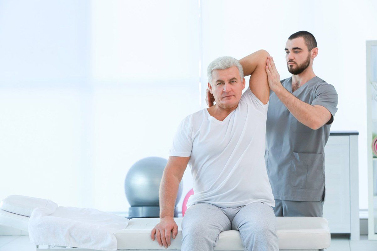 Men Physiotherapist Working With Patient — Physio in Port Stephens, NSW Men Physiotherapist Working With Patient —