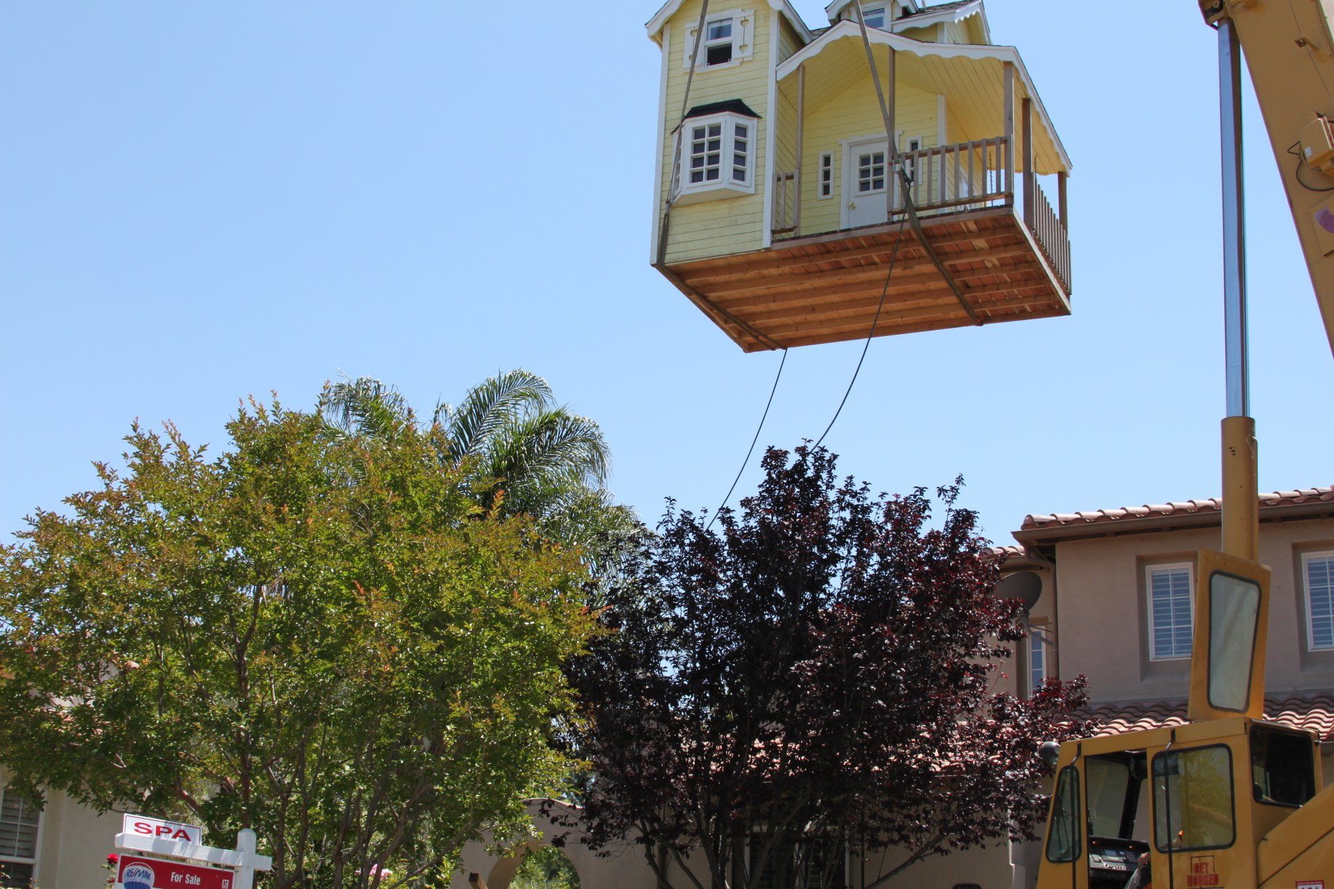 Yellow House Lifted by a Crane — Lancaster, CA — Get Hooked Crane Service