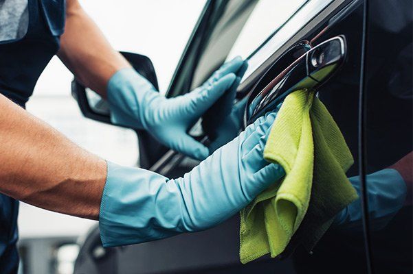man cleaning a limo