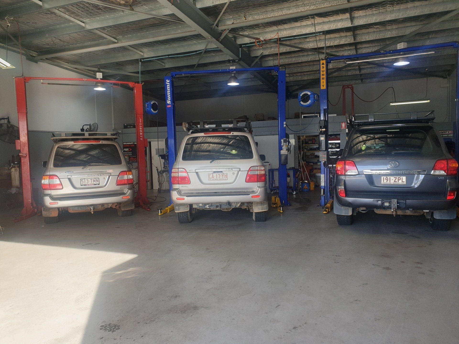 Cars Under Hoists in Workshop — Wayne Boylett Mechanical In Bungalow, QLD Cars Under Hoists in Workshop — Wayne Boylett Mechanical In Bungalow, QLD