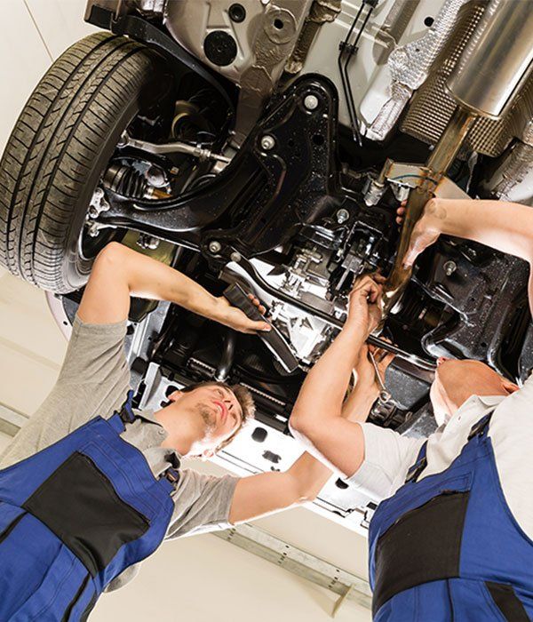 Two men working under 4WD — Wayne Boylett Mechanical In Bungalow, QLD Two men working under 4WD — Wayne Boylett Mechanical In Bungalow, QLD
