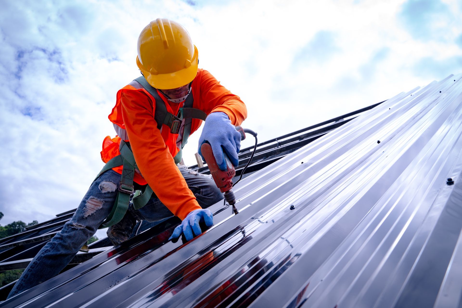 Roofer working on steel roof