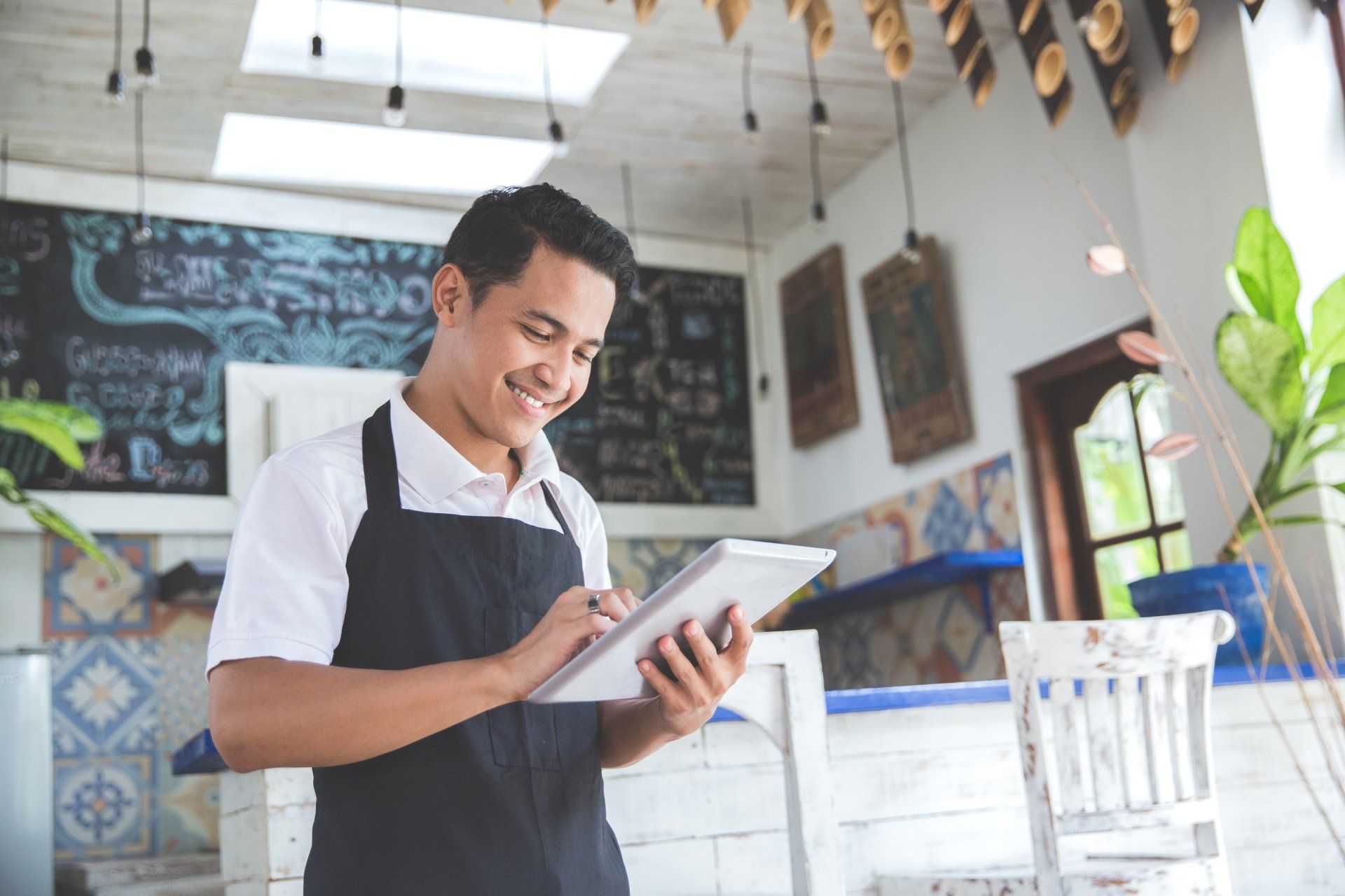 small business owner looking at checking account on ipad
