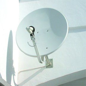 If you require aerial repair in Wednesbury call 0121 5306785 white satellite dish on side of a white wall