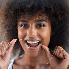 Prevention and Cleaning Young Woman Flossing