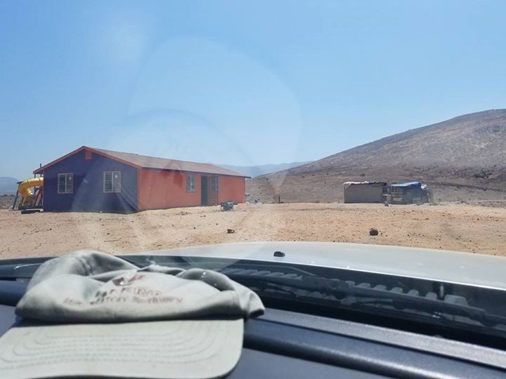A hat is laying on the windshield of a car