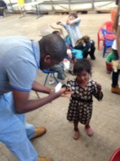 A man standing next to a little girl in a polka dot dress