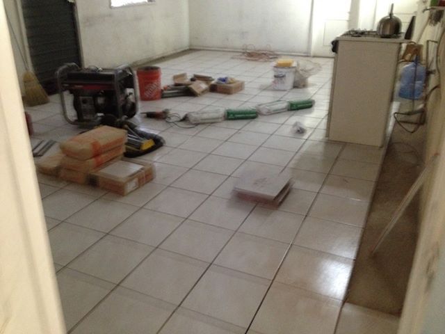A room with tile floors and boxes on the floor
