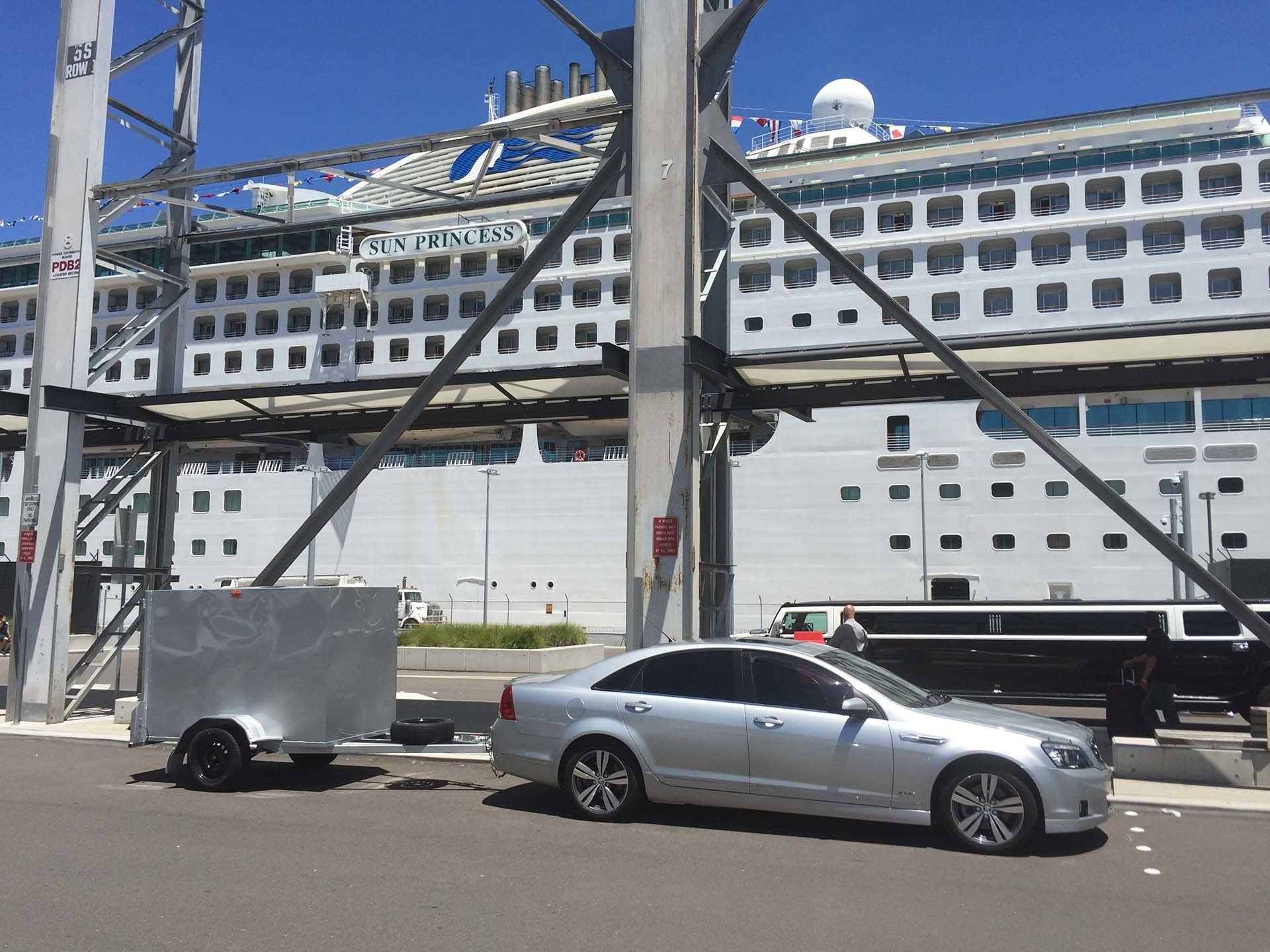 limousine with luggage trailer at cruise shop
