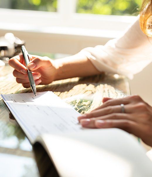 Businesswoman Signing Cheque