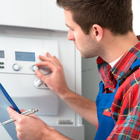man looking at boiler settings