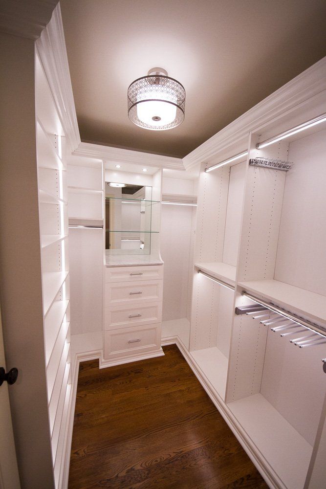 This small but well appointed Chatham, NJ walk-in has incorporated marble, mirrors and glass shelves.